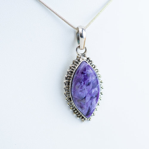 Sterling silver Charoite necklace set in a sterling silver bezel with a white background